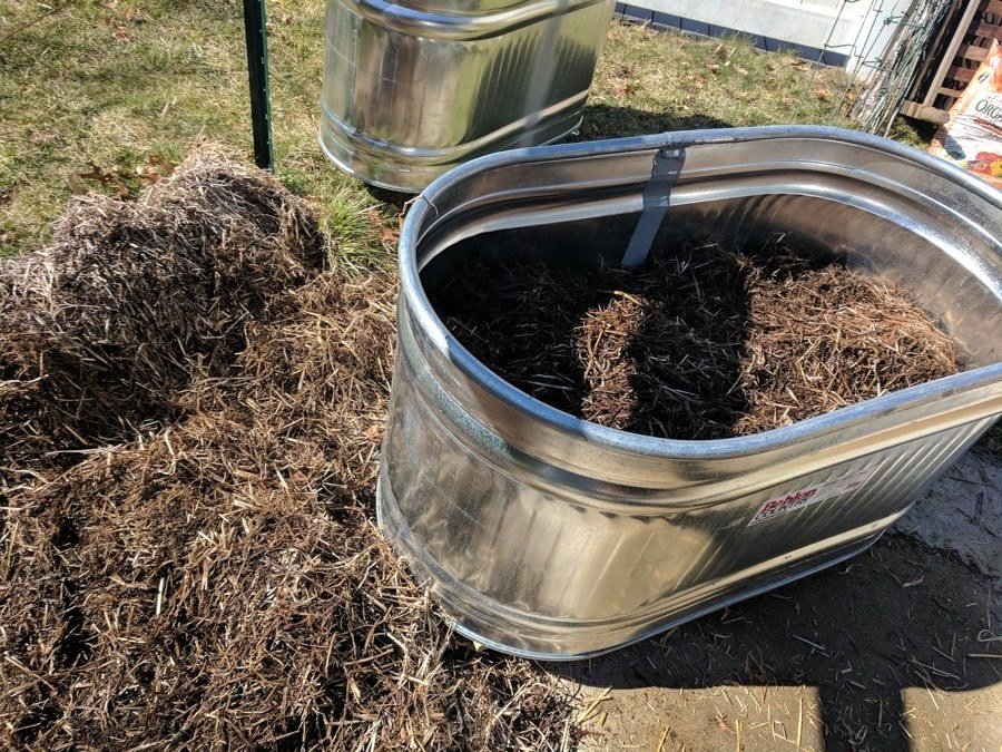 straw in water trough planters